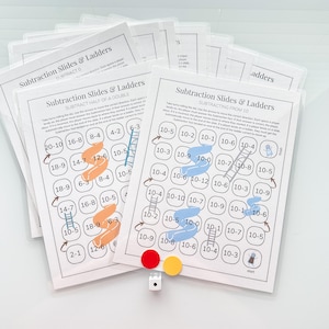 May include: Two printable game boards for a subtraction game called "Subtraction Slides & Ladders". The game boards feature colorful slides and ladders with numbers on them. The game is designed to help children learn subtraction.