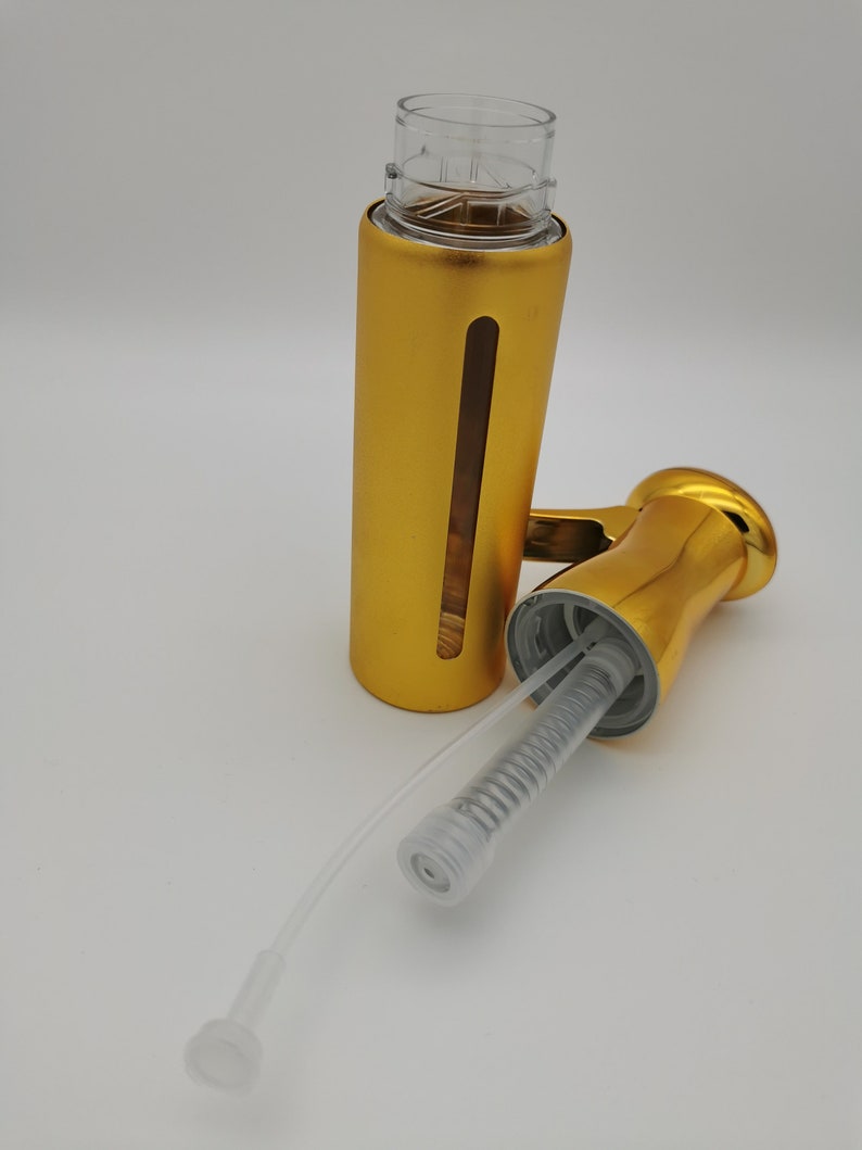 May include: Gold metal soap dispenser bottle with a clear plastic pump and a clear plastic tube. The bottle is separated from the pump and tube.
