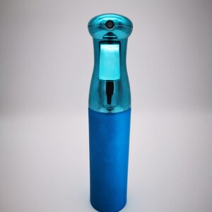 May include: A blue plastic spray bottle with a silver top. The bottle is designed for dispensing liquids.
