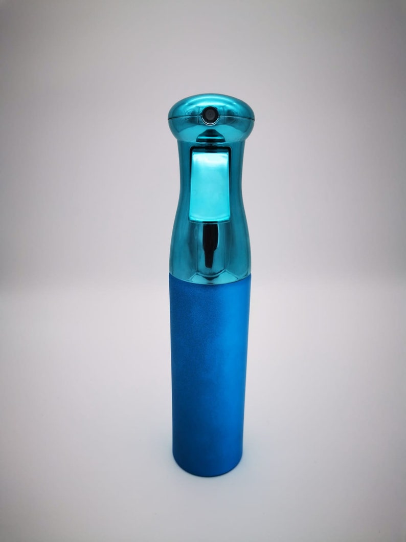 May include: A blue plastic spray bottle with a silver top. The bottle is designed for dispensing liquids.