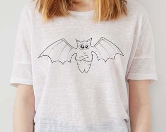 May include: A white t-shirt with a black cartoon bat design. The bat has large eyes and is drawn in a simple style.