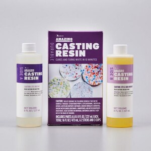 May include: A casting resin kit with two bottles labeled "Side A" and "Side B", and a purple box. The bottles contain clear and yellow liquids, each with a net volume of 8 fl oz / 237 ml. The box reads "Amazing Casting Resin".