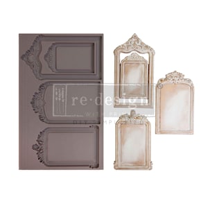May include: A gray silicone mold with three ornate frame designs and three finished decorative frames in cream and gold. The finished frames have a distressed, vintage appearance. The text "re-design with prima" is visible on the mold.