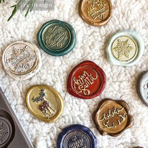 May include: Assortment of Christmas themed wax seals with various designs and colors, including "Merry Christmas", "North Pole Post Office", "Ho Ho Ho", "Santa", and a reindeer.