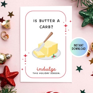 May include: A white card with red text that reads "Is butter a carb?" and a cartoon illustration of a stick of butter on a plate. The text "indulge this holiday season" is written in red below the illustration.