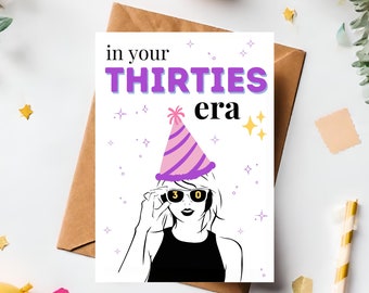 May include: A white card with a purple and pink party hat on a woman's head. The text on the card reads "in your THIRTIES era".