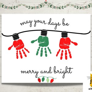 May include: A white rectangular print featuring the black text may your days be merry and bright. The design includes a black string with three handprint light bulbs in red, green, and red, plus a small row of red and green light bulbs at the bottom.