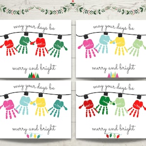 May include: Four rectangular cards featuring handprint art shaped like Christmas light bulbs hanging from a black wire. Each card displays the text "may your days be merry and bright" in black script. The handprints appear in various colors including red, green, pink, light blue, and yellow.
