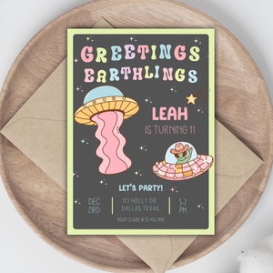 May include: A colorful invitation card with a black background and a green alien in a cowboy hat flying in a pink and yellow spaceship. The text on the card reads "Greetings Earthlings Leah is turning 11 Let's Party! Dec 3rd 123 Holly Dr Dallas Texas 5-7 PM RSVP Clare @ 123-456-7810"