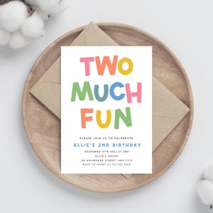 May include: A colorful birthday invitation with the text "TWO MUCH FUN" in large, playful letters. The invitation is for Ellie's 2nd birthday party, which will be held on December 10th, 2023 at 2pm at Ellie's house. The address and RSVP information are included.