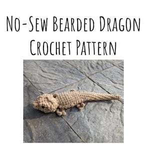 May include: A crocheted bearded dragon toy, beige in colour, lying on a grey tiled surface. The toy is made with a no-sew technique.  "NO-SEW BEARDED DRAGON CROCHET PATTERN" is written in black text above the image.