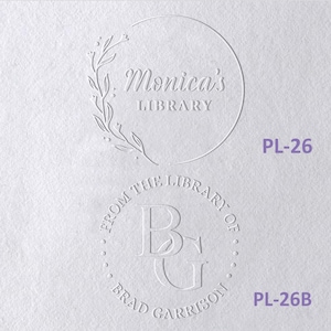 May include: Two circular embossed designs on white paper. The top design features a floral branch and the text Monica's LIBRARY. The bottom design features the initials BG surrounded by the text FROM THE LIBRARY OF BRAD GARRISON. Labels PL-26 and PL-26B appear in purple text.