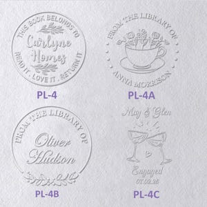 May include: Four circular and decorative embossed designs on a textured white surface. The designs include text such as This Book Belongs To Carlyne Homes, From The Library Of Anna Morrison, From The Library Of Oliver Hudson, and May & Glen Engaged.