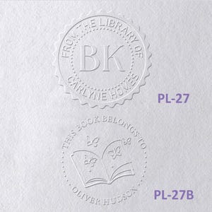 May include: Two circular embossed book stamps on white paper. The top stamp reads FROM THE LIBRARY OF BK CARLYNE HOMES. The bottom stamp features an open book with butterflies and reads THIS BOOK BELONGS TO OLIVER HUDSON. Labels PL-27 and PL-27B appear.
