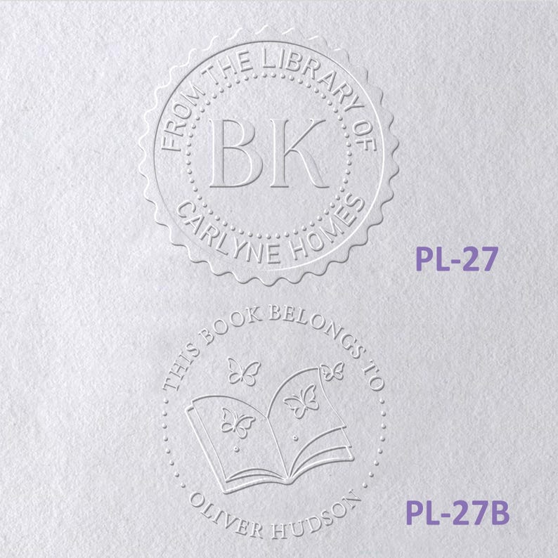 May include: Two circular embossed book stamps on white paper. The top stamp reads FROM THE LIBRARY OF BK CARLYNE HOMES. The bottom stamp features an open book with butterflies and reads THIS BOOK BELONGS TO OLIVER HUDSON. Labels PL-27 and PL-27B appear.