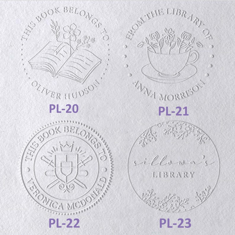 May include: Four circular embossed book embosser designs on white paper. PL-20 features an open book with flowers and the text 'THIS BOOK BELONGS TO OLIVER HUDSON'. PL-21 shows a teacup with flowers and 'FROM THE LIBRARY OF ANNA MORRISON'. PL-22 displays a shield and swords with 'THIS BOOK BELONGS TO VERONICA MCDONALD'. PL-23 shows floral borders with 'sillowa's LIBRARY'.