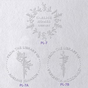 May include: Three white embossed paper designs. Top design features a floral wreath surrounding the text CARLINE HOMES LIBRARY and label PL-7. Bottom left design shows a sword with flowers, text FROM THE LIBRARY OF ADELINE JOHNSON and PL-7A. Bottom right shows a sword with flowers, text FROM THE LIBRARY OF VERONICA MCDONALD and PL-7B.