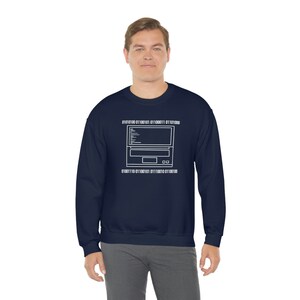 May include: A navy blue sweatshirt featuring a white outline of a computer with binary code above and below it. The code reads "01001100 01100101 01100011 01100011 01110100" and "01001110 01101100 01101001 01110010 01110100".