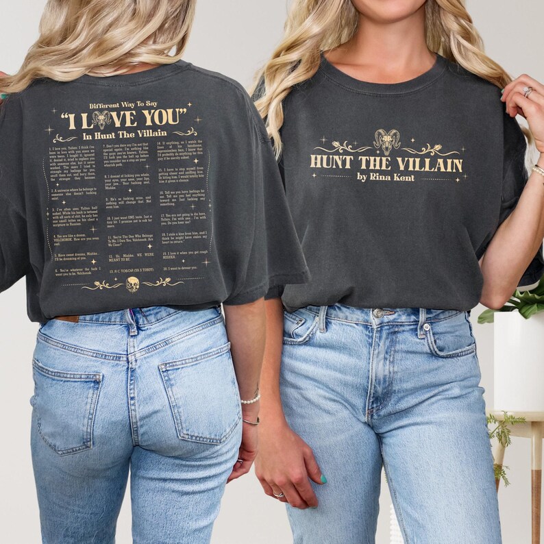 May include: Dark gray t-shirts with text. One shirt says "I LOVE YOU" and "In Hunt The Villain" with a list of phrases. The other shirt says "HUNT THE VILLAIN by Rina Kent" with a ram graphic.