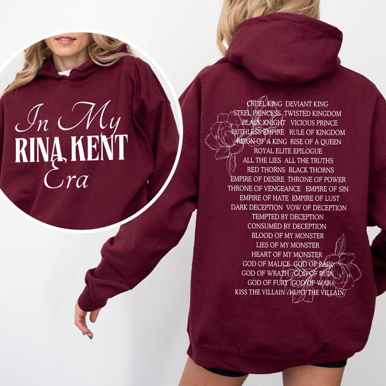 May include: Burgundy hoodie with white text "In My Rina Kent Era" on the front. The back features a list of phrases and floral illustrations in white. A comfortable, casual sweatshirt for fans of the author.