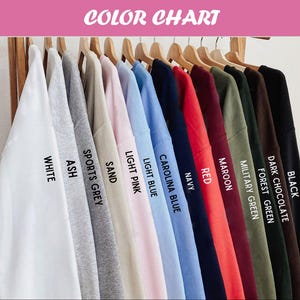 May include: A color chart displays a variety of sweatshirts in different colors, including white, ash, sports grey, sand, light pink, light blue, carolina blue, navy, red, maroon, military green, forest green, dark chocolate, and black. The text "COLOR CHART" is at the top.
