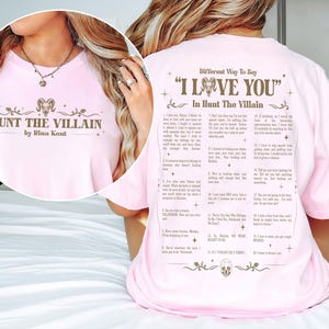 May include: A light pink t-shirt with the text "HUNT THE VILLAIN by Rina Kent" on the front. The back of the shirt features a list titled "Different Way To Say 'I Love You' In Hunt The Villain".