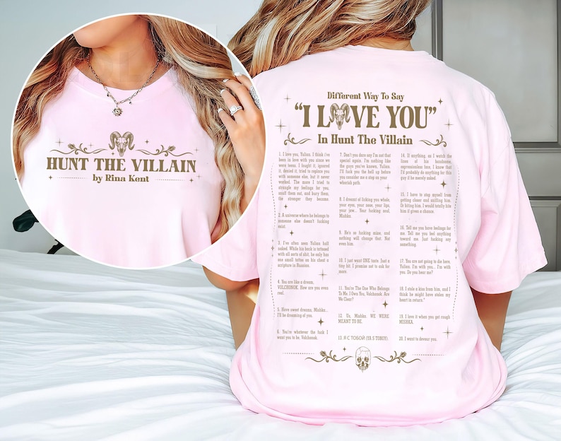 May include: A light pink t-shirt with the text "HUNT THE VILLAIN by Rina Kent" on the front. The back of the shirt features a list titled "Different Way To Say 'I Love You' In Hunt The Villain".