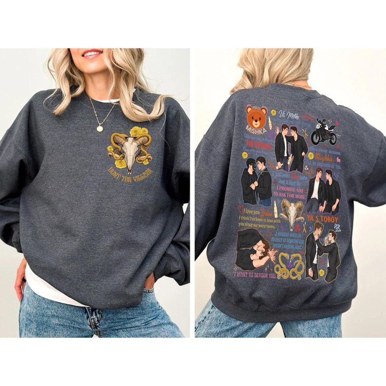 May include: Dark gray sweatshirt with a graphic on the front featuring a skull with horns and the text "Hunt the Villain". The back of the sweatshirt has multiple graphics and text, including images of two men, a teddy bear, and a motorcycle.