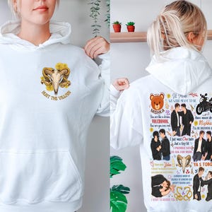 May include: White hoodie with a front graphic of a ram skull and yellow roses, with the text "HUNT THE VILLAIN". The back features a collage of illustrations and text, including the words "Mishka" and "Ya's Toboy".