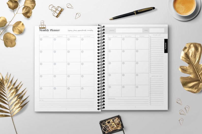 May include: A white monthly planner with a black spiral binding. The planner has a calendar section with days of the week and a to-do list section. The planner has the words "Monthly Planner" at the top.