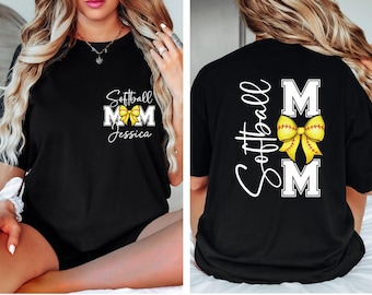 May include: Black t-shirt with a softball theme. The front features the text "Softball Mom Jessica" with a yellow bow graphic. The back of the shirt displays "Softball Mom" with a yellow softball bow graphic.