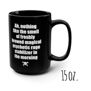 May include: Black 15 ounce coffee mug with white text that reads "Ah, nothing like the smell of freshly brewed magical psychotic rage stabilizer in the morning" and a skull and crossbones symbol.