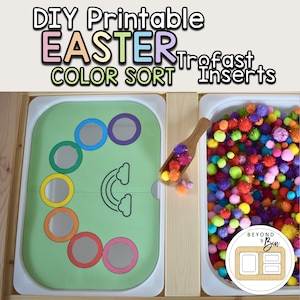 May include: A DIY printable Easter color sort activity with a green mat featuring rainbow-colored circles and a rainbow graphic. A wooden scoop holds colorful pom-poms, and a bin is filled with more pom-poms. Text reads "DIY Printable Easter Color Sort Trofast Inserts."