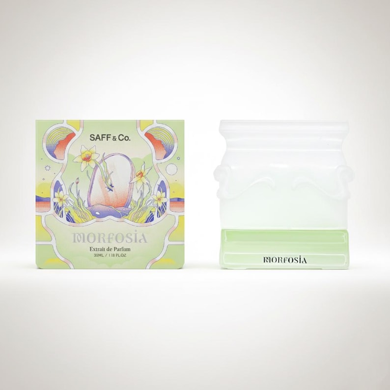 May include: A perfume bottle and box set. The box is light green with the text "SAFF & Co." and "MORFOSIA". The bottle is clear with a light green base. The set is on a white background.