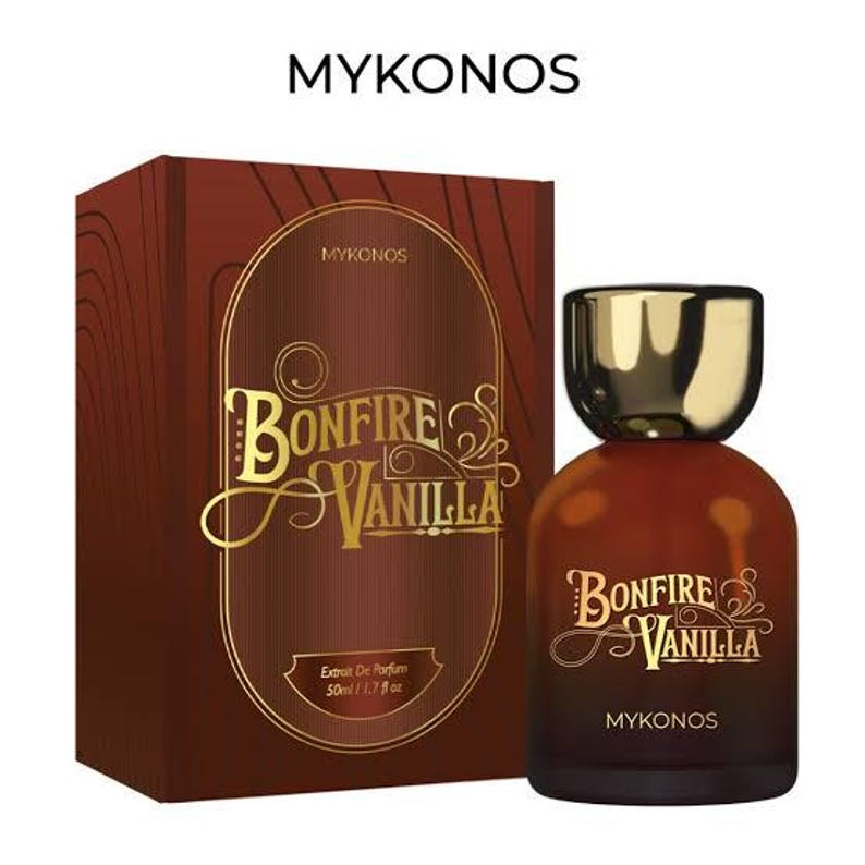 May include: A perfume bottle and box set. The bottle is brown with a gold cap, and the box is brown with gold lettering that reads "BONFIRE VANILLA" and "MYKONOS". The bottle contains 1.7 fl oz of perfume.
