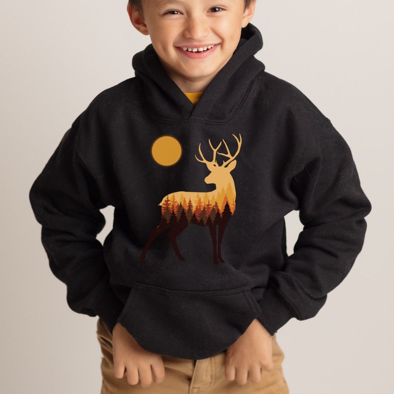 May include: Black hooded sweatshirt with a graphic of a deer silhouette with a full moon and forest inside the deer.