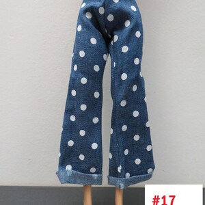 May include: Blue denim doll pants with white polka dots. The pants have a wide leg design and are cuffed at the bottom. The tag in the image reads #17.