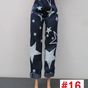 May include: Dark blue doll pants with a white star pattern. The pants have a cuffed hem and are displayed on a doll. The number "16" is in a red box in the lower right corner.
