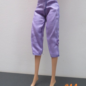 May include: Lavender-colored doll pants with a cropped length, featuring vertical ribbing and blue stitching. The pants have a button detail on the side. The number "#14" is in the bottom right corner.