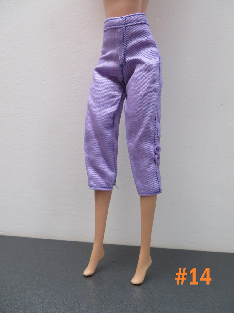 May include: Lavender-colored doll pants with a cropped length, featuring vertical ribbing and blue stitching. The pants have a button detail on the side. The number "#14" is in the bottom right corner.