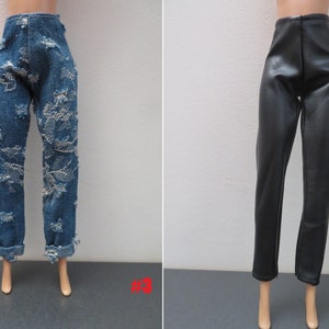 May include: Two pairs of doll pants. One pair is blue denim with distressed detailing and rolled cuffs. The other pair is black faux leather with a high waist and a straight leg.