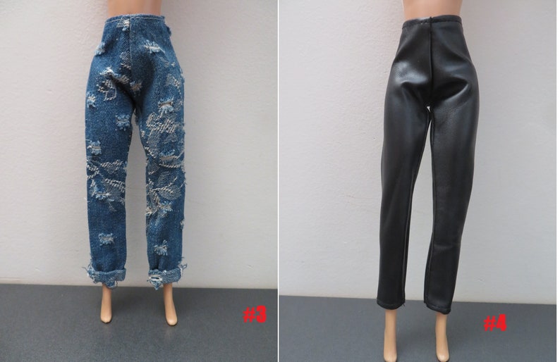 May include: Two pairs of doll pants. One pair is blue denim with distressed detailing and rolled cuffs. The other pair is black faux leather with a high waist and a straight leg.