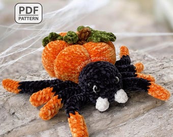 May include: A handmade crochet spider with a pumpkin body. The spider is black with orange-tipped legs and white fangs. The pumpkin is orange with green leaves. The image includes the text "PDF PATTERN".