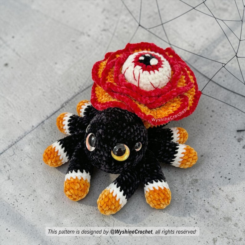 Spooky cute flower spider crochet pattern PDF featuring a rose-shaped body, watchful eye, eight legs, and Halloween amigurumi charm