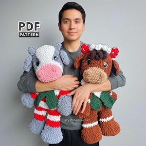 May include: Two plush cow toys. One is gray, white, and pink, wearing a red and white striped outfit with green accents. The other is brown with white and red accents. The text "PDF PATTERN" is in the upper left corner. The text "WyshireCrochet" is in the lower right corner.
