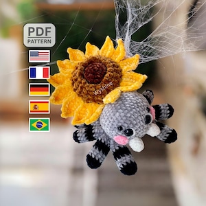 May include: A crocheted spider with a sunflower head. The spider is gray with black and white striped legs and pink cheeks. The sunflower has yellow petals and a brown center. The image includes a "PDF PATTERN" label and flags.