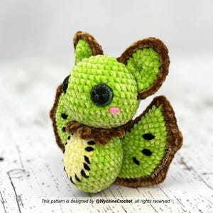 Kiwi Bat Crochet Pattern finished amigurumi with green kiwi wings, black seed embroidery, and cute bat plushie details