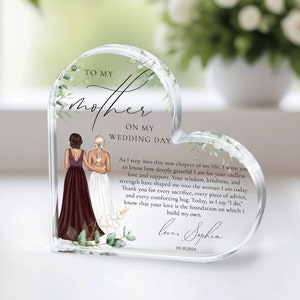 May include: A heart-shaped clear glass keepsake with a floral design and a message to a mother on her daughter's wedding day. The message reads "To my mother on my wedding day. As I step into this new chapter of my life, I want you to know how deeply grateful I am for your endless love and support. Your wisdom, kindness, and strength have shaped me into the woman I am today. Thank you for every sacrifice, every piece of advice, and every comforting hug. Today, as I say "I do," know that your love is the foundation on which I build my own. Love, Sophia 05.10.2024"