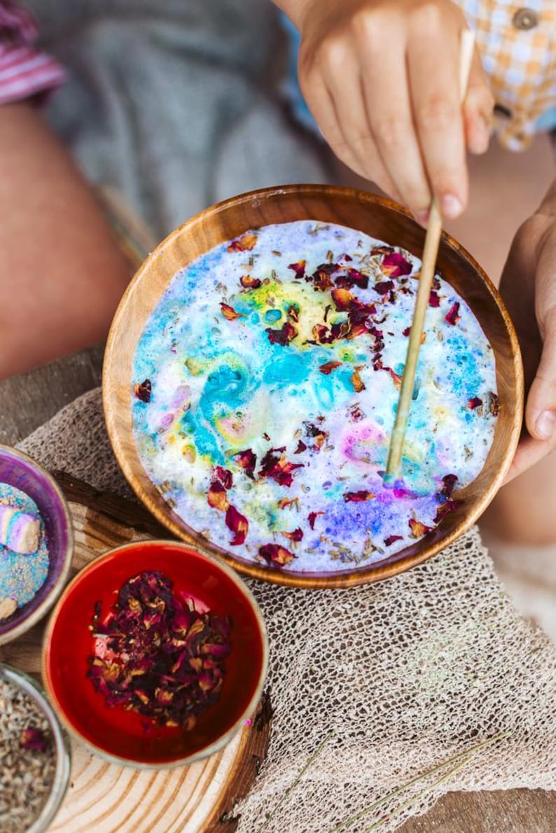 Fairy themed sensory play setup with magical ingredients and colourful potion play textures