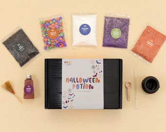 May include: A Halloween Potion kit featuring a black box with a label reading Halloween Potion, surrounded by five clear bags of colorful ingredients, a small bottle of red liquid, a miniature broom, a wooden spoon, a dropper, and a black cauldron.